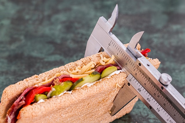 A sandwich being measured by a ruler