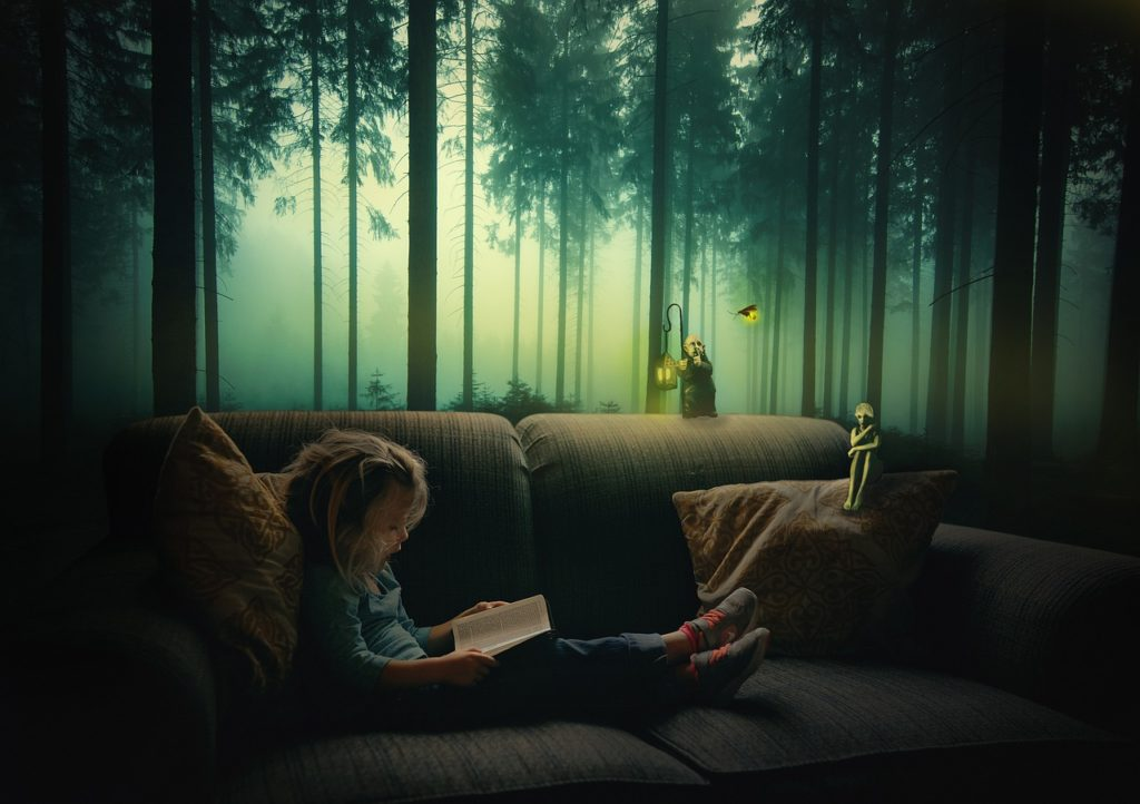 Girl reading a book at  night 