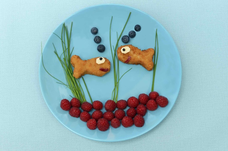 Kids snacks of fish and fruits