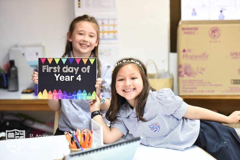 2 girls showing a first day of year 4 sign