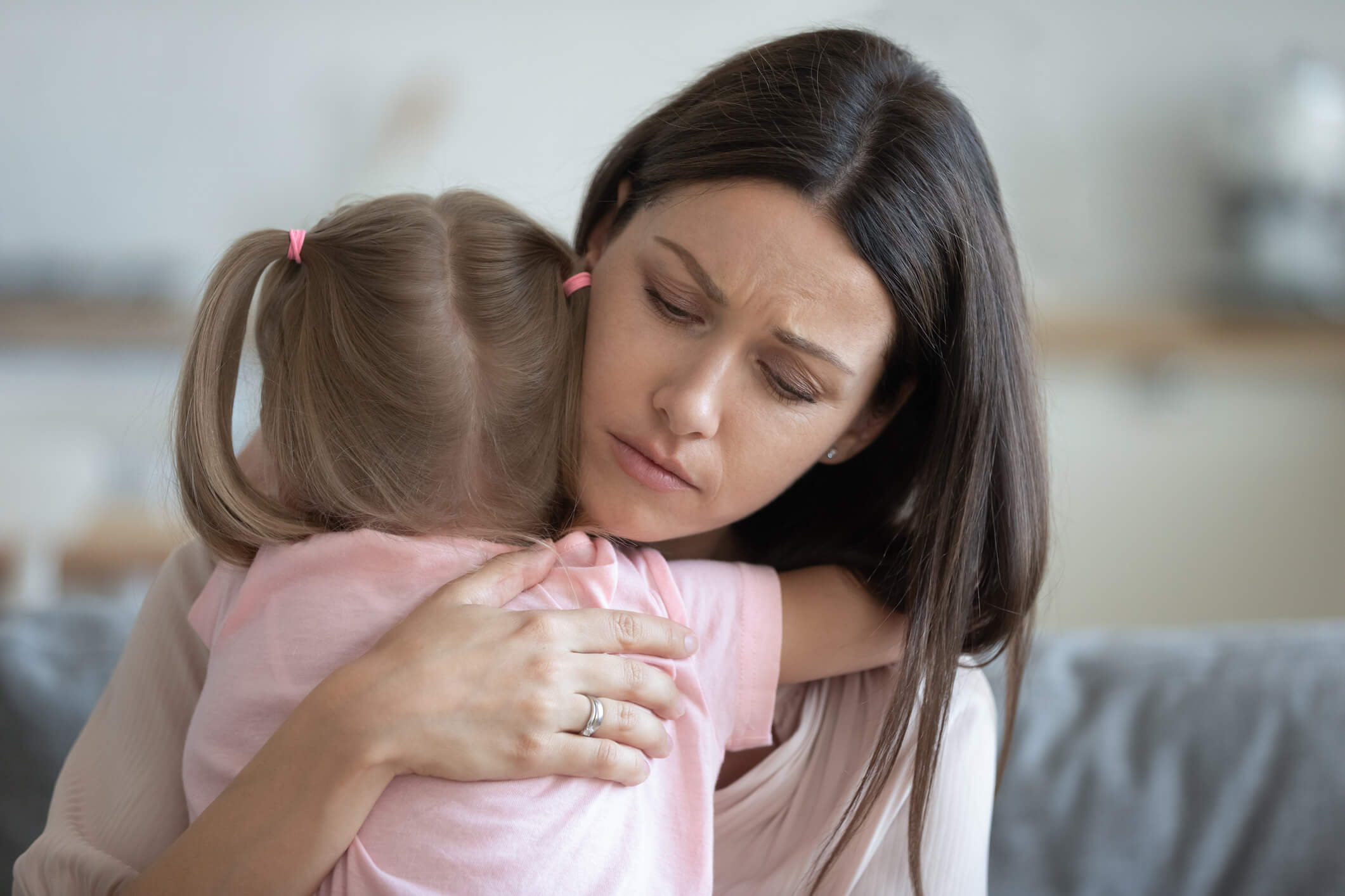 Mom hug small girl