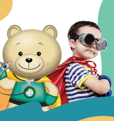 Small boy dressed as superman with teddy bear